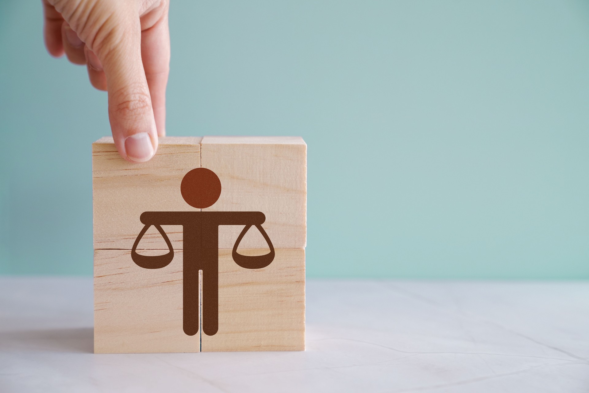 Hand holding wooden block with Ethics word, business ethics and corporate compliance concept